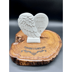 White heart-shaped memorial plaque with angel wings on a wood base