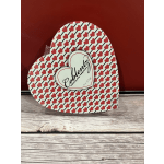 Heart-shaped box of chocolates with red heart pattern