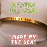 Gold bracelet engraved with the words "Made by the Sea"