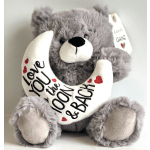 Gray teddy bear holding a white crescent pillow with love text