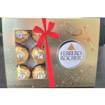 Ferrero Rocher chocolates in a gold gift box with a red ribbon