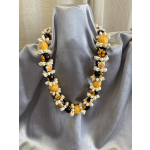 Shell bead necklace draped over silver satin fabric