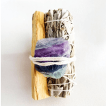 Bundle of dried sage with a purple crystal and wood piece