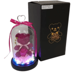 Glass dome gift with pink teddy bear and rose on lit base beside a black gift box