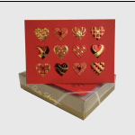 Red heart-patterned gift card box on a gold box