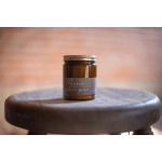 Amber jar candle on a wooden stool