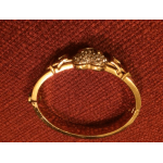 Gold ring with a cluster of small stones on red fabric