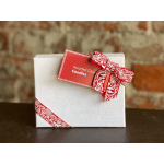 White gift box with a red ribbon and an assorted chocolates tag