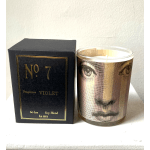 Violet-scented candle in a glass jar beside its black box