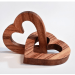 Two interlocking wooden heart sculptures on a white background