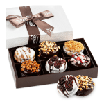 Box of decorated chocolate-covered donuts with a ribboned lid