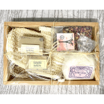 Gift basket with bath salts, rose petal sachets, and a mesh bath sponge