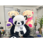 Three plush teddy bears, including a panda in front, are displayed indoors