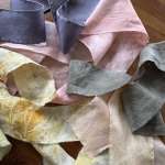 Assorted fabric ribbon strips in pink, gray, cream, and yellow tones