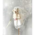 Small teddy bear dressed as a bride with lace veil and dress on a stick decoration