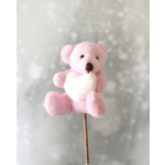 Small pink teddy bear pick holding a white heart on a stick