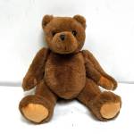 Brown teddy bear plush toy sitting upright