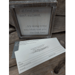 Framed quote sign beside a florist gift card and envelope