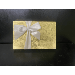 Gold gift box with a white satin ribbon bow