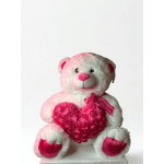 White teddy bear holding a pink heart with ribbon accents