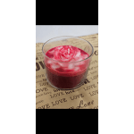 Pink rose-shaped candle in a clear glass holder