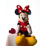 Minnie Mouse plush with a red polka-dot bow and red roses beside it