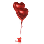 Two red heart-shaped balloons tied to a small gift bundle