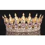 Jeweled gold crown with pink and clear stones on a black background