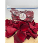 Bag of red rose petals on a table