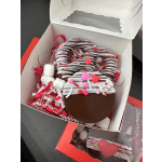 Box of chocolate-covered treats with pink and red Valentine decorations