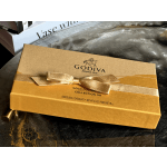 Gold Godiva chocolate box tied with a ribbon