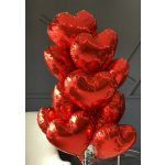 Cluster of red heart-shaped balloons indoors