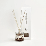 Glass reed diffuser bottle with dried rose petals and a white box