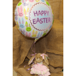 Easter balloon with bunny faces and a plush bunny doll below