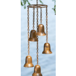 Five bronze bells hanging from chains against a blue sky