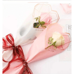 Wrapped roses in pink and white paper with a red ribbon