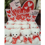 Valentine's Day display of white teddy bears in heart-patterned boxes