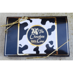 Chocolate gift box with cow-print label and gold ribbon
