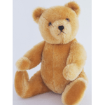 Plush teddy bear with golden-brown fur on a white background