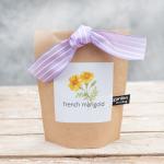 Brown paper gift bag with a lavender striped ribbon and marigold label