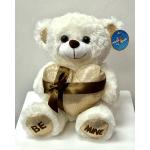 White teddy bear holding a gold heart with a brown ribbon