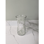 Clear ribbed glass vase on a marble-patterned surface