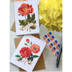 Greeting cards with painted flowers beside a yellow bouquet