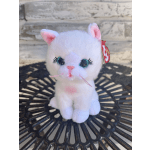 White plush cat with pink ears and glittery eyes sitting on a black table