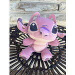 Pink plush toy sitting on a black metal table