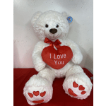 White teddy bear holding a red heart that says I Love You