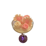 Small floral arrangement in a stemmed glass with peach daisies and roses