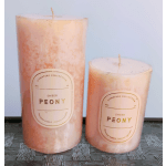 Two pink pillar candles labeled Sheer Peony