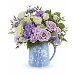 Lavender and white bouquet in a blue floral pitcher