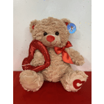 Teddy bear holding a red heart and wearing a red bow